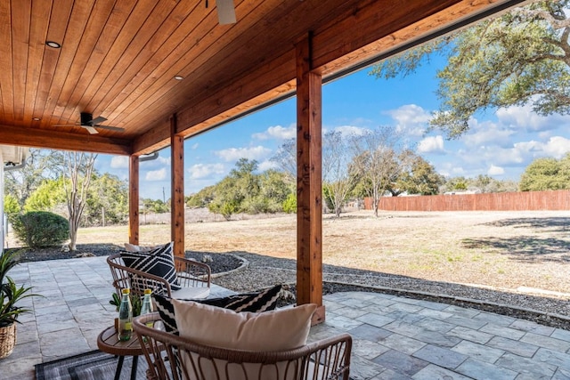 view of patio featuring fence and a ceiling fan