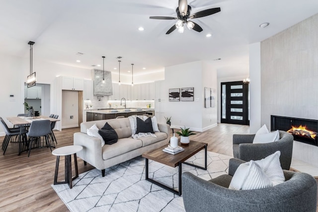 15400 Fm 1826, Austin, TX 78737 - living area featuring light wood-type flooring, ceiling fan, a tile fireplace, and recessed lighting