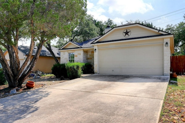 ranch-style house with an attached garage, stone siding, a chimney, and concrete driveway