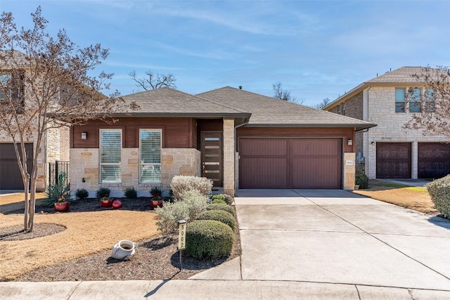 view of front facade with a garage, stone siding, a shingled roof, and driveway