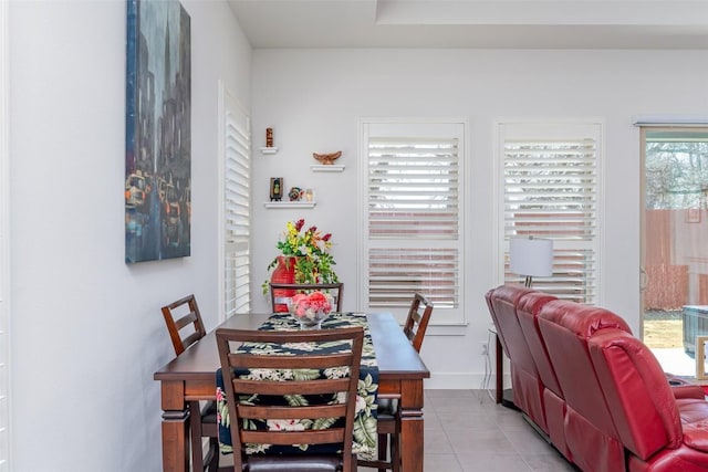 dining space featuring light tile patterned floors