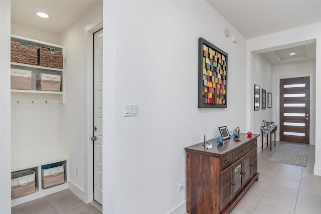 entryway with recessed lighting, light tile patterned flooring, and baseboards