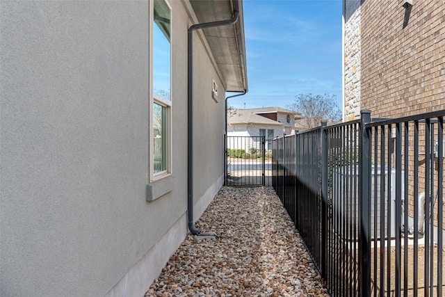 view of property exterior featuring a gate and fence