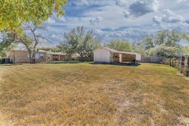 view of yard with an outbuilding, a fenced backyard, cooling unit, and a storage shed