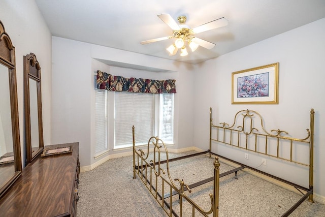 bedroom with ceiling fan, carpet, and baseboards