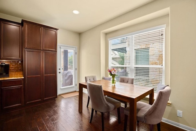 dining space with baseboards, dark wood finished floors, and recessed lighting