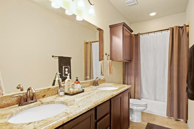 bathroom with double vanity, shower / bath combination with curtain, visible vents, and a sink