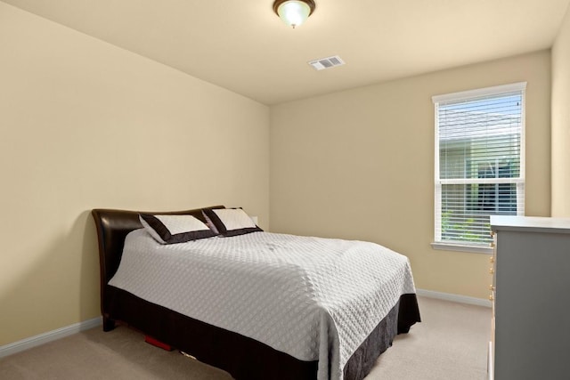 bedroom featuring light colored carpet, visible vents, and baseboards