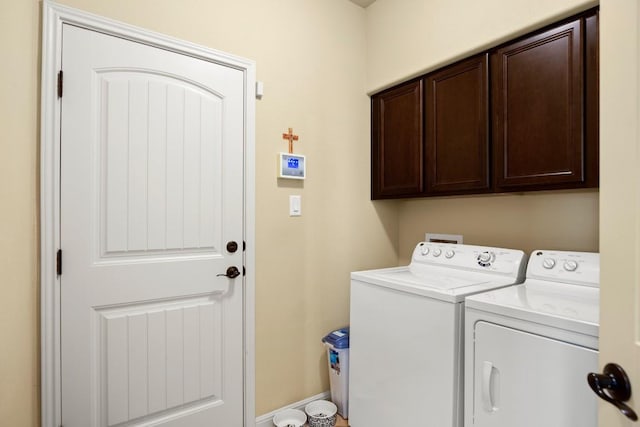 washroom featuring cabinet space and independent washer and dryer