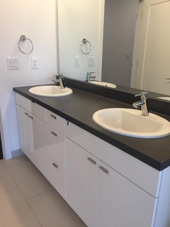 bathroom featuring double vanity, a sink, and tile patterned floors