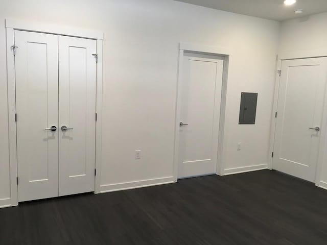 4361 S Congress Ave Unit 304, Austin, TX 78745 - unfurnished bedroom featuring electric panel, dark wood-style floors, recessed lighting, and a closet