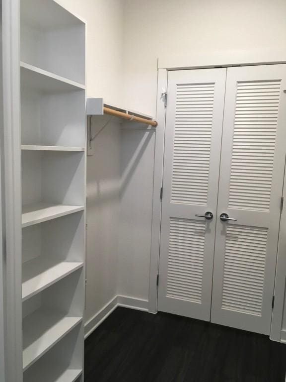 4361 S Congress Ave Unit 304, Austin, TX 78745 - walk in closet with dark wood finished floors