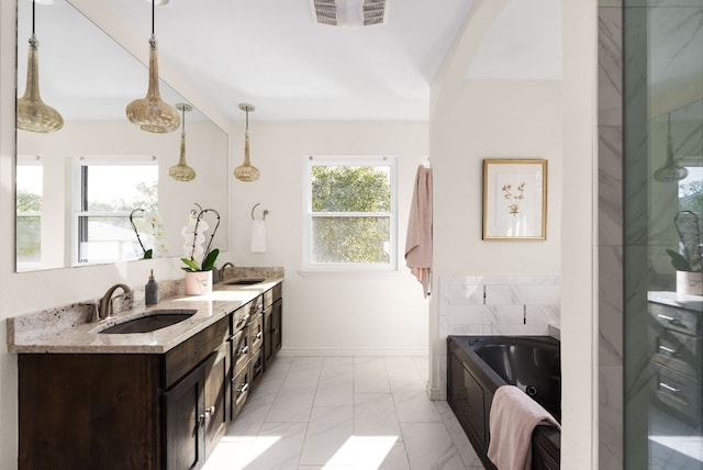 bathroom featuring double vanity, visible vents, a jetted tub, a fireplace, and a sink