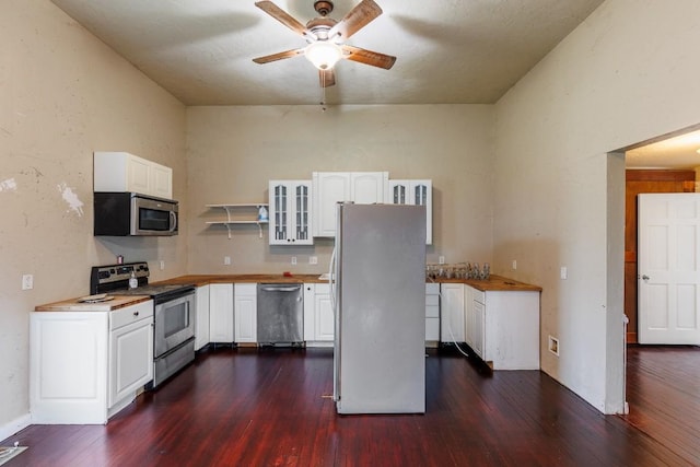 kitchen featuring open shelves, glass insert cabinets, appliances with stainless steel finishes, dark wood-type flooring, and white cabinets