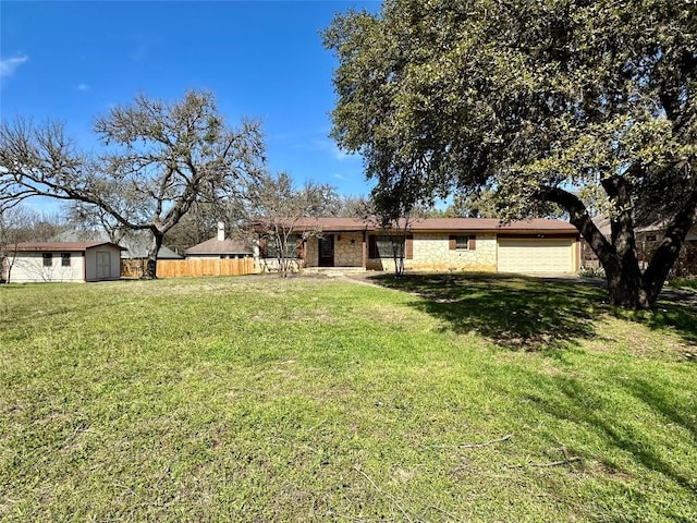 exterior space with stone siding, a front lawn, an outdoor structure, and fence