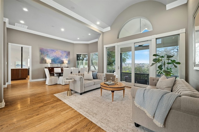 living room with light wood finished floors, plenty of natural light, visible vents, and baseboards