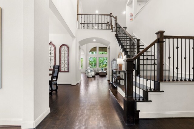 3804 Venezia Vw, Leander, TX 78641 - foyer with a high ceiling, arched walkways, hardwood / wood-style flooring, and stairway