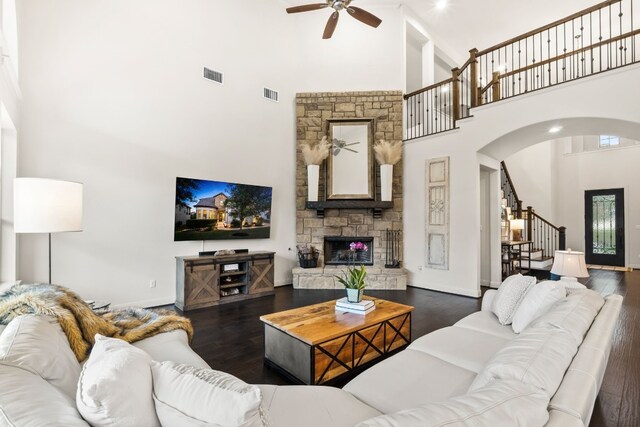 3804 Venezia Vw, Leander, TX 78641 - living room featuring ceiling fan, a towering ceiling, stairs, arched walkways, and wood finished floors