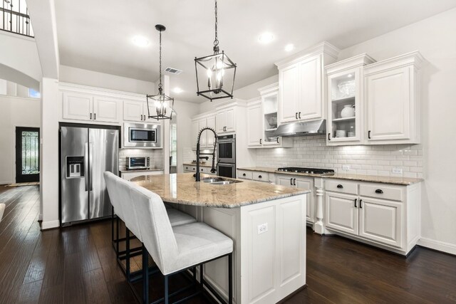 3804 Venezia Vw, Leander, TX 78641 - kitchen featuring appliances with stainless steel finishes, a chandelier, recessed lighting, dark wood-type flooring, and white cabinetry