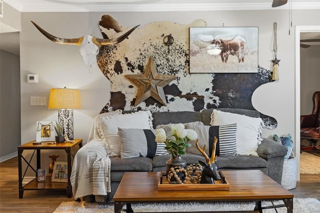 living room with ornamental molding, wood finished floors, and baseboards