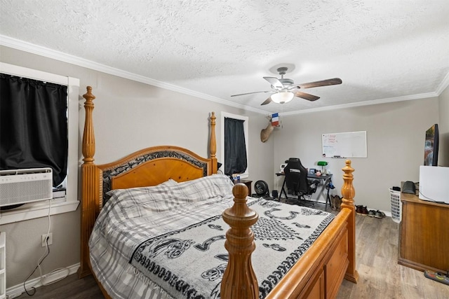 bedroom featuring ceiling fan, ornamental molding, cooling unit, and light wood-style flooring