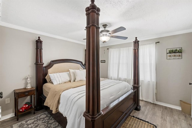 bedroom featuring a textured ceiling, a ceiling fan, baseboards, ornamental molding, and light wood finished floors