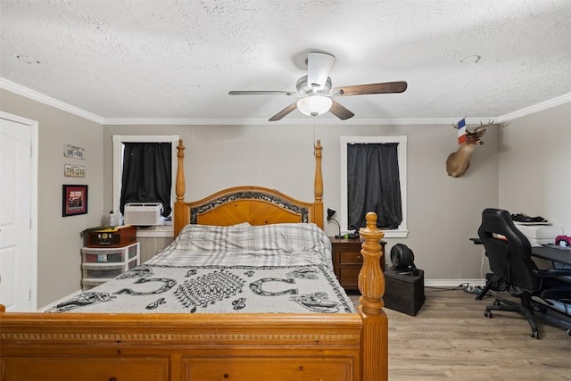 bedroom with ornamental molding, light wood-style flooring, a textured ceiling, and a ceiling fan