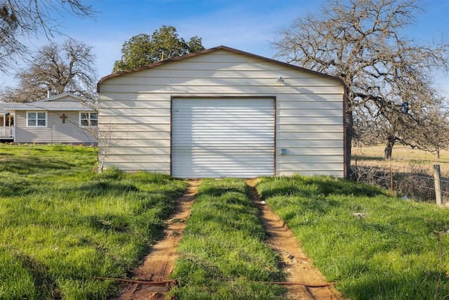 detached garage with driveway and fence