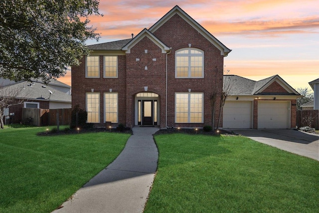 view of front of property featuring a garage, fence, concrete driveway, and a front yard