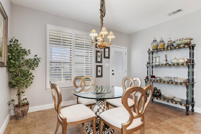 tiled dining room featuring baseboards, visible vents, and a chandelier