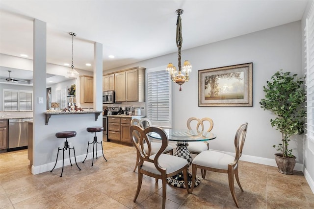 dining area featuring baseboards, a chandelier, and recessed lighting