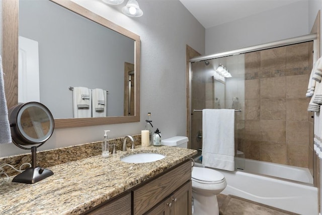 full bath featuring tile patterned flooring, vanity, toilet, and bath / shower combo with glass door