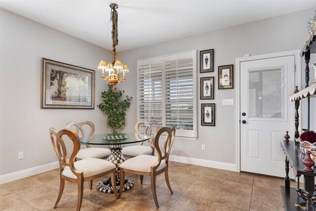 dining room with baseboards, light tile patterned flooring, and a notable chandelier