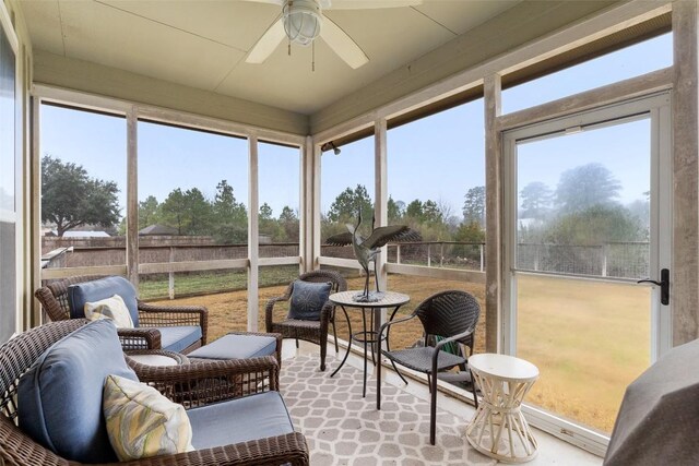 sunroom / solarium with a ceiling fan