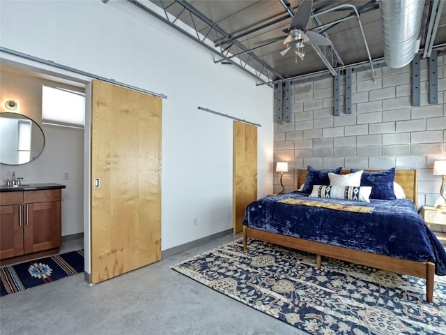 bedroom with concrete floors, a sink, and baseboards