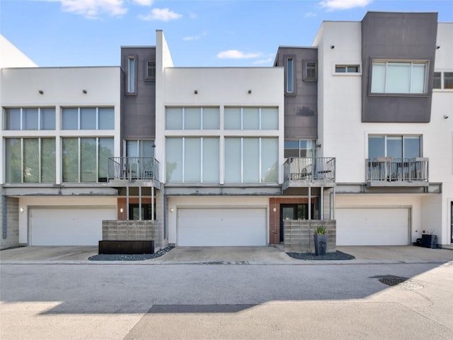 view of building exterior with driveway and an attached garage