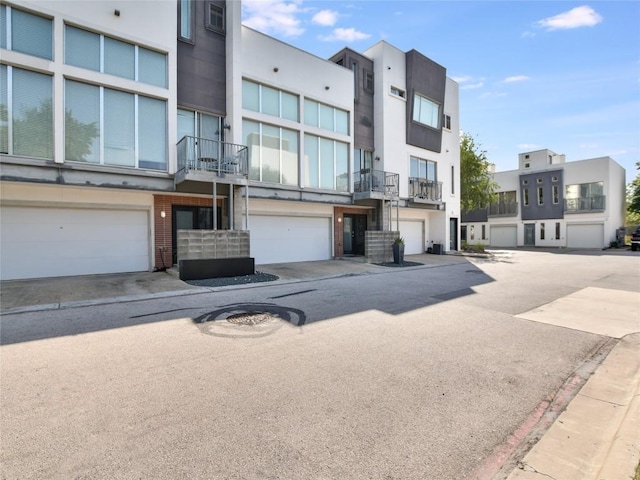 view of building exterior with a garage and driveway