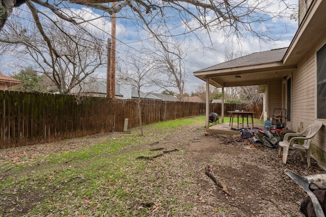 view of yard featuring a patio area and a fenced backyard