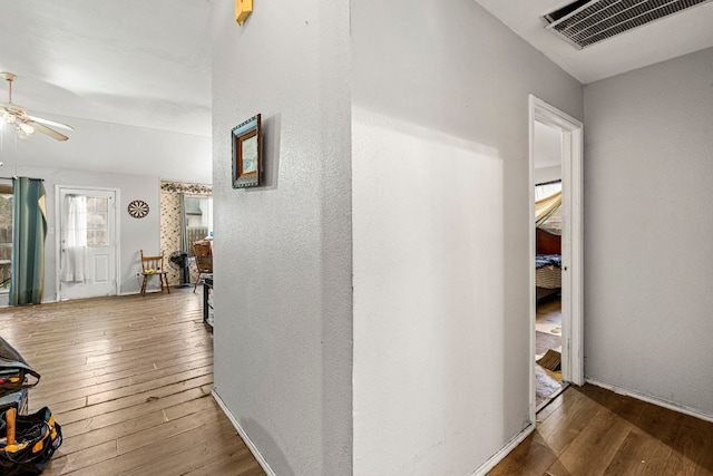 hall with dark wood-type flooring and visible vents