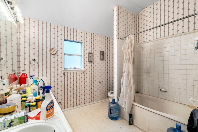 full bathroom featuring toilet, vanity, tile patterned floors, shower / bath combo with shower curtain, and wallpapered walls