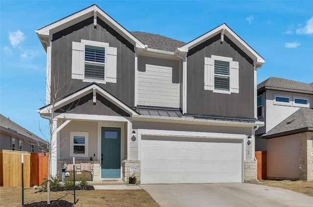 view of front of property with metal roof, a garage, fence, driveway, and a standing seam roof