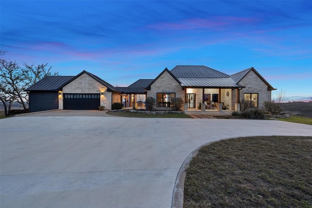 modern farmhouse style home with a porch, a standing seam roof, and metal roof