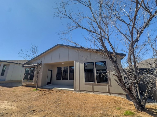 849 Cypress Ln, Cottonwood Shores, TX 78657 - rear view of house featuring board and batten siding and a patio