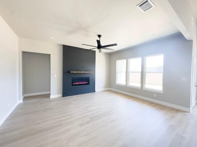 849 Cypress Ln, Cottonwood Shores, TX 78657 - unfurnished living room featuring ceiling fan, light wood-style floors, and a fireplace