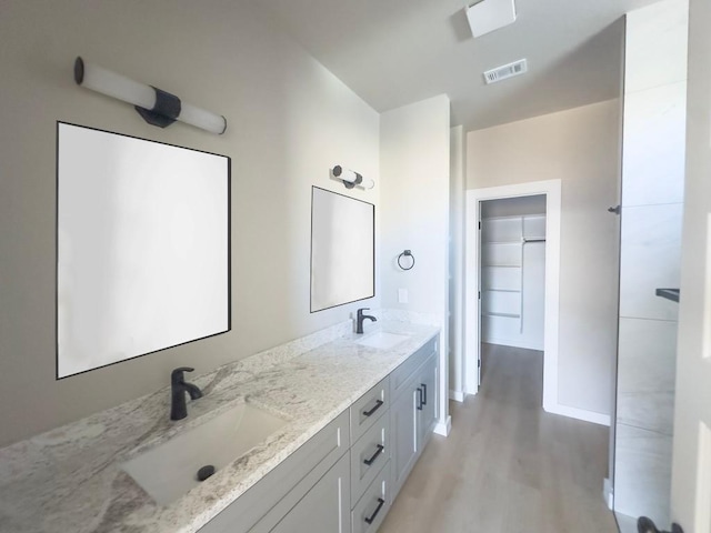 849 Cypress Ln, Cottonwood Shores, TX 78657 - full bathroom with wood finished floors and double vanity