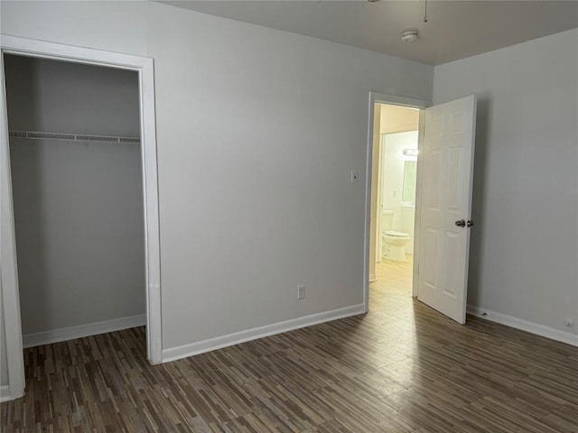 unfurnished bedroom featuring wood finished floors and a closet