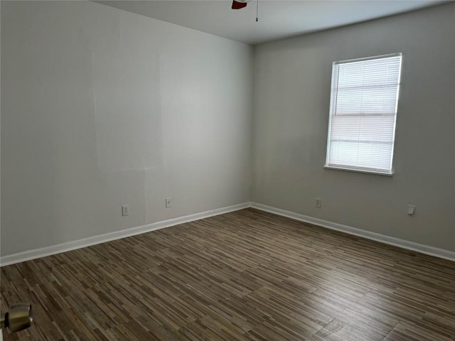 empty room featuring dark wood finished floors and ceiling fan