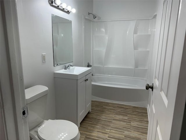 bathroom featuring vanity, shower / washtub combination, and wood finished floors