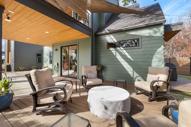 wooden terrace with fence and area for grilling