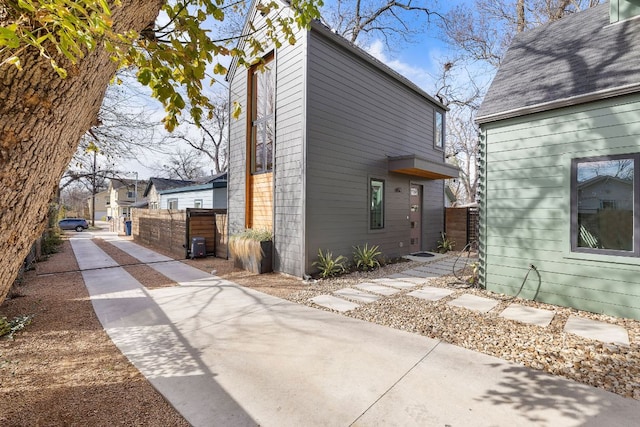 view of property exterior featuring fence